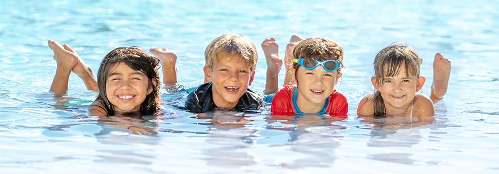 Aquaplex Four smiling students in the pool