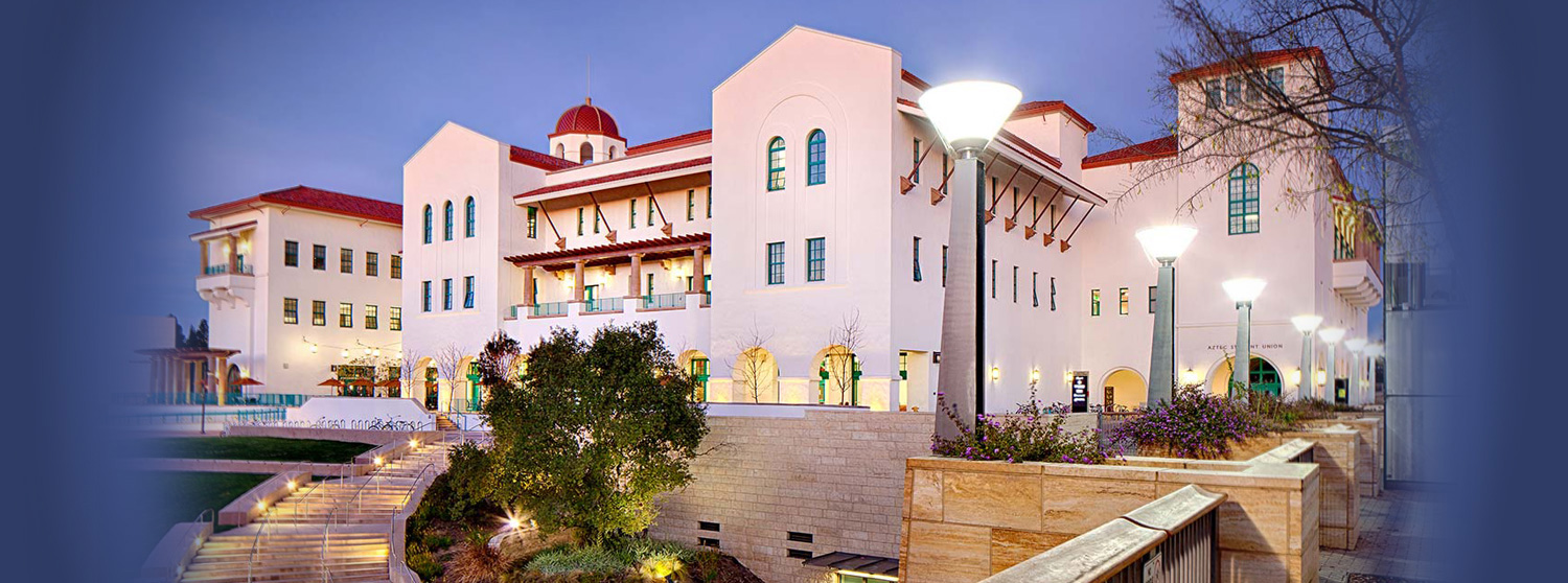 Conrad Prebys Aztec Student Union building lit up against evening sky